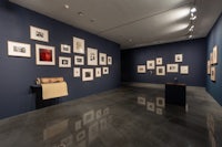 a blue room with a lot of pictures on the wall